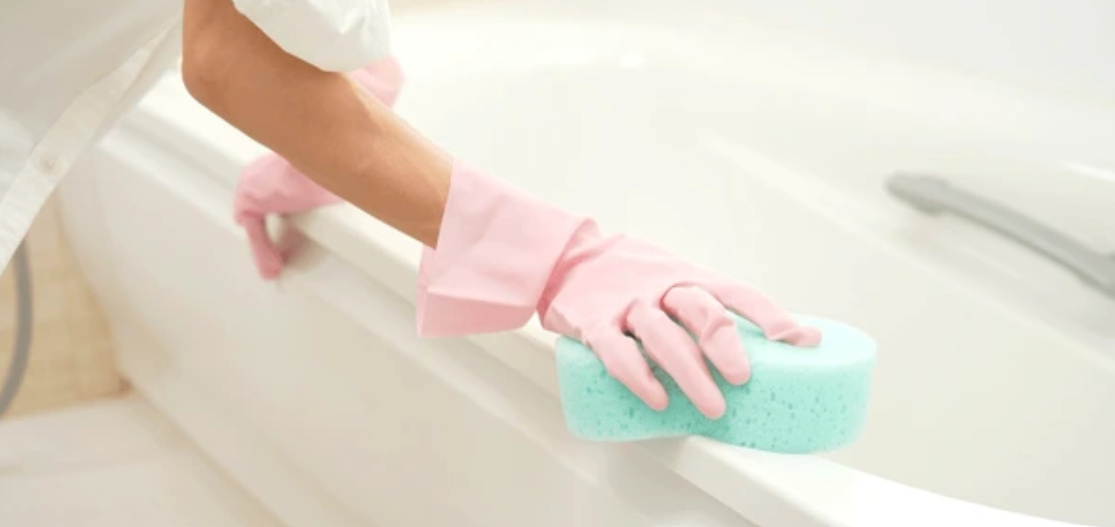 person cleaning bathtub